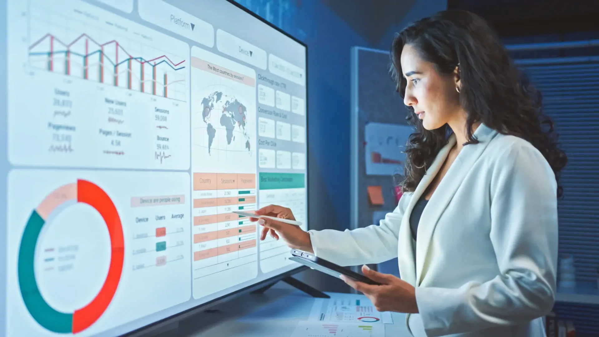 Woman analyzing data on large digital screen.